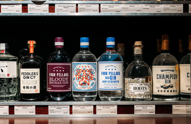 A close up of gin bottles on display.