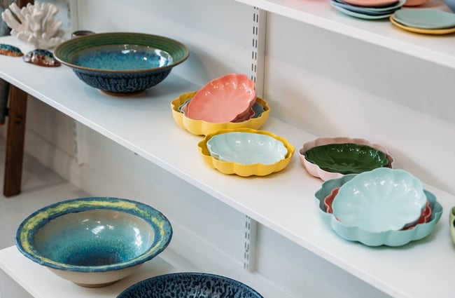A close up on the colourful ceramics on the shelf at The Wobbly Pot.