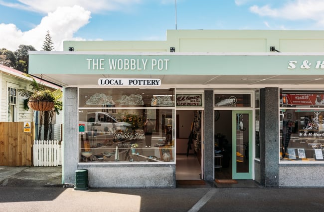 Mint green building exterior of The Wobbly Pot.