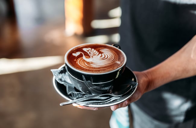 A close up of a hot chocolate in a hand.