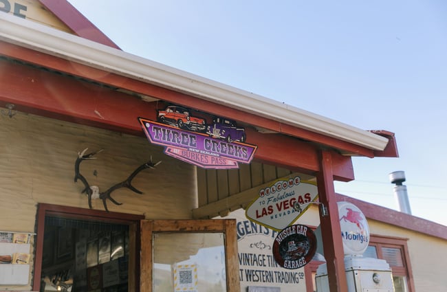 Close up of a retro Three Creeks sign on a building.