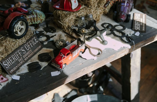 A close up of vintage cars and old tools on a table at Three Creeks.