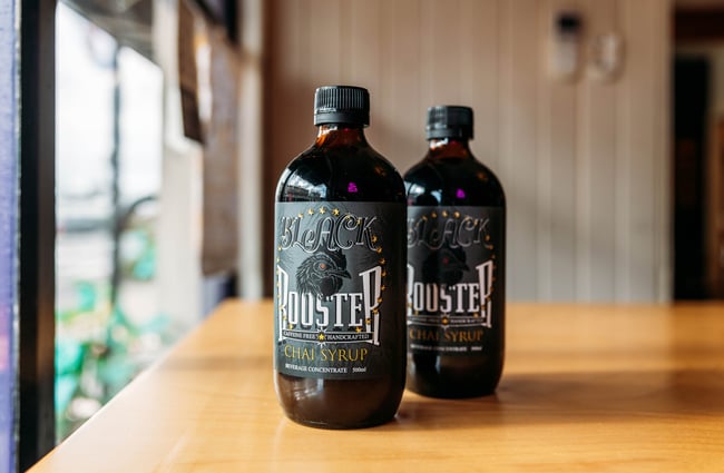 Two bottles of chai syrup on a table inside Three High Street cafe in Rangitikei.