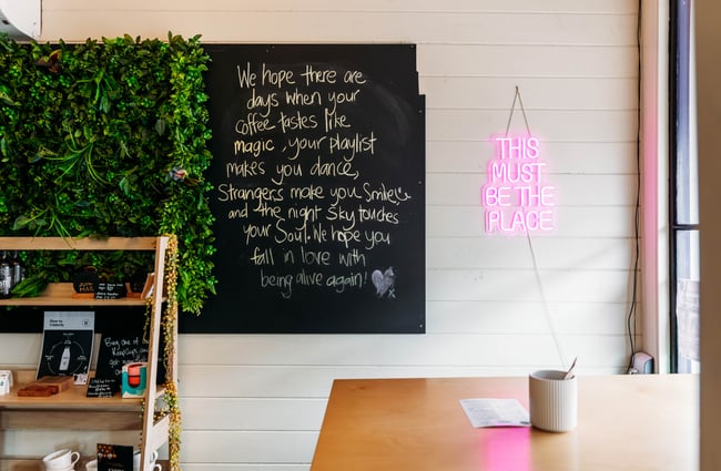A blackboard sign on a white wall inside Three High Street cafe in Rangitikei.