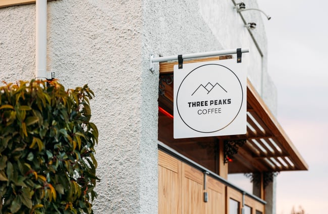 A Three Peaks sign on a building.