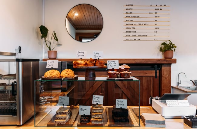 Scones and muffins on a cafe counter.