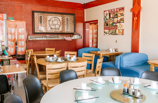 A packed dining room inside a Chinese restaurant.