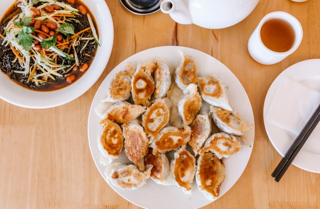 A birdseye view of a large plate of dumplings.