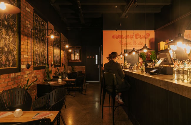 A woman sitting at a bar.