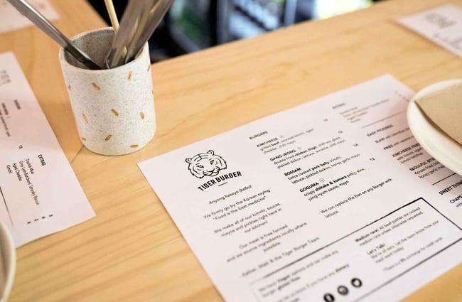 White menu on a wooden table.