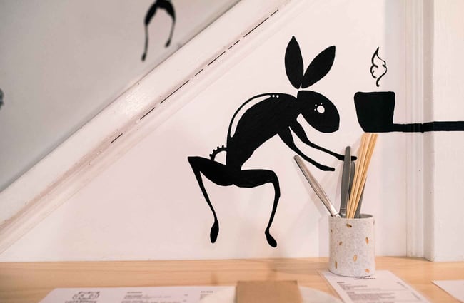 Black rabbit on a white wall.