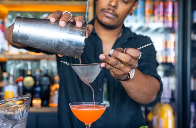 Bartender mixing up cocktail at Tini Bar in Akaroa