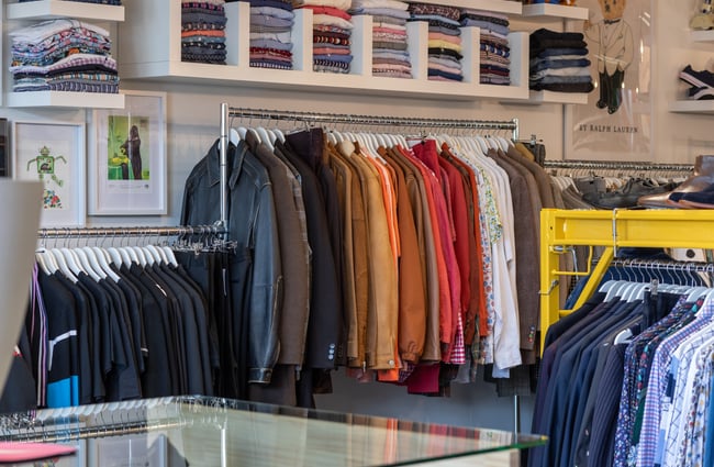 Multiple racks of clothing on display at To Be Continued.