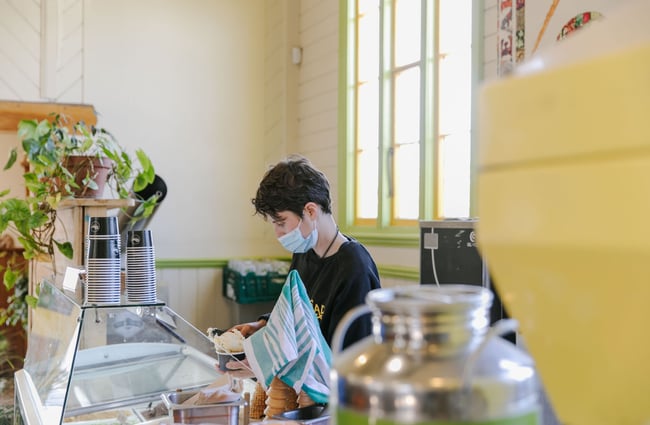 Man scooping ice cream at Toad Hall, Motueka.