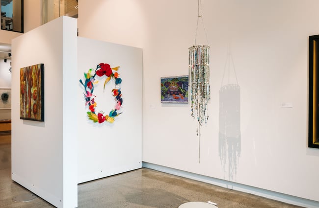 Works of art on display on white walls.
