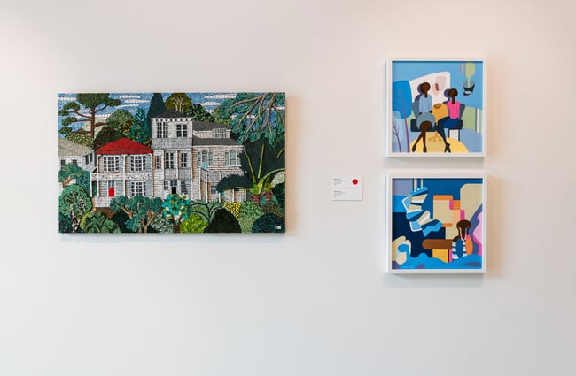 Three paintings on a white wall.
