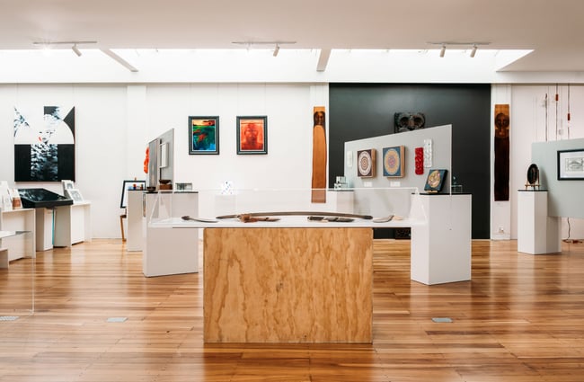 A large gallery full of colourful works of art.