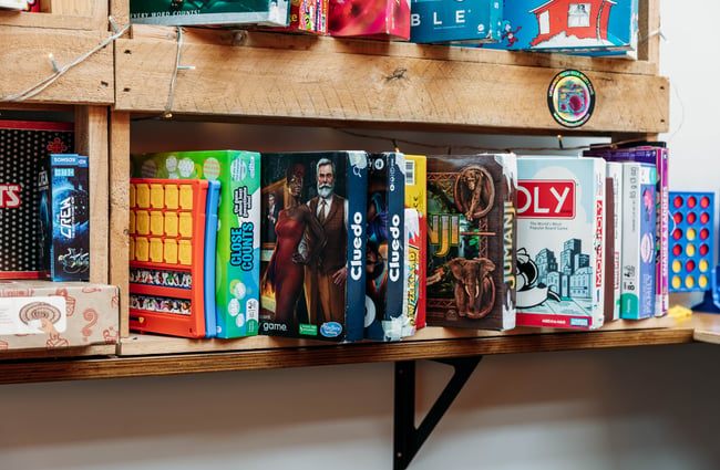 A close up of board games on shelves.