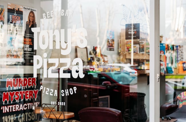 Window signage at Tony's Pizza.