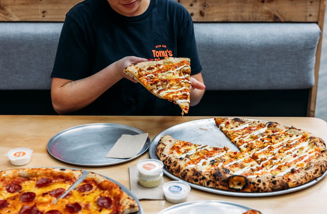 A close up of a slice of pizza on a plate.