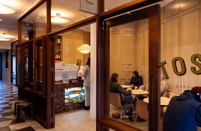 Looking through the window of Tosca cafe in Auckland with customer ordering coffee at the counter