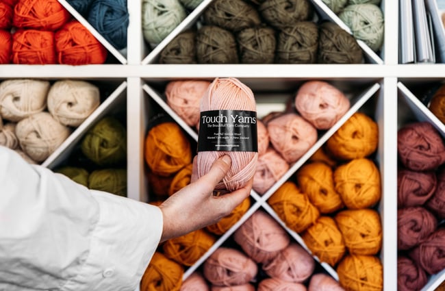 A hand holding a ball of yarn.