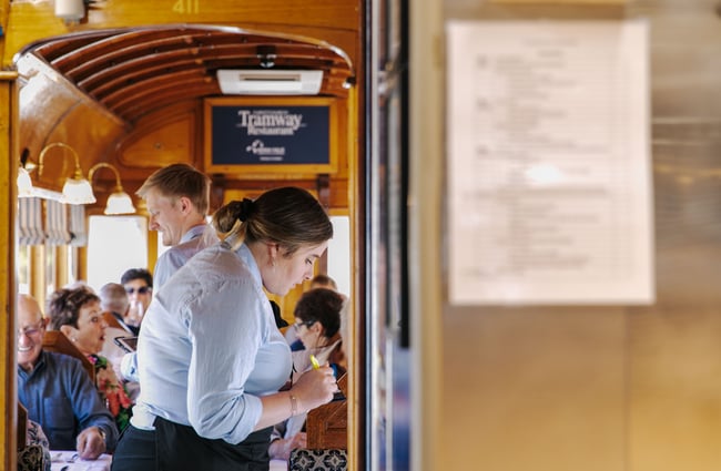 Waitress taking order on the tram.