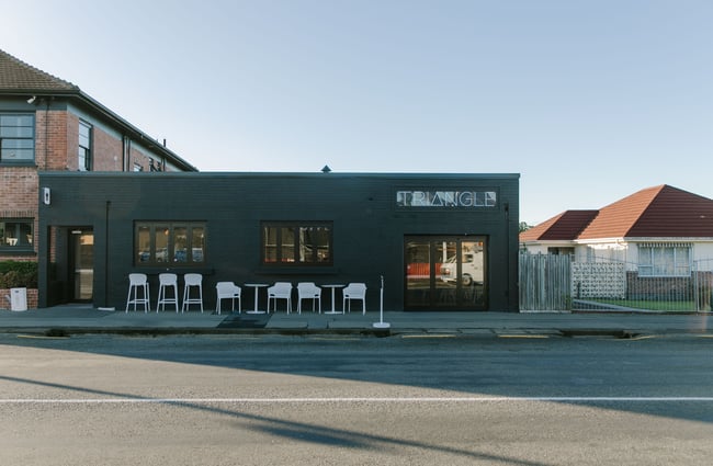 The painted black brick exterior of Triangle Espresso in Ashburton.