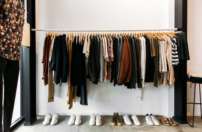 Fashionable clothing on racks inside the True store.