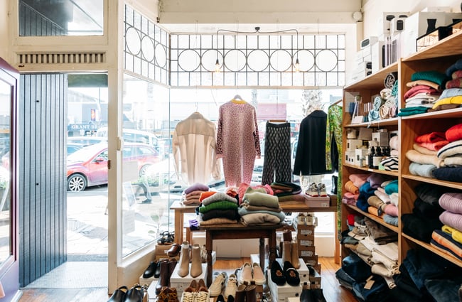 Clothing on display inside the window at Truly Gisborne.