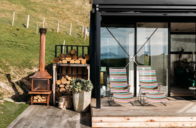 A little outdoor fireplace next to a balcony.