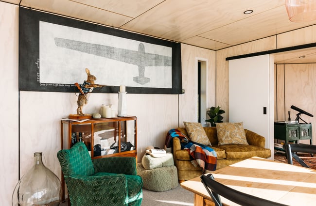 Vintage couches and chairs inside the living room at Tunapo Escape.