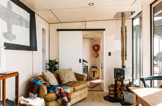 An inside fireplace with couches.