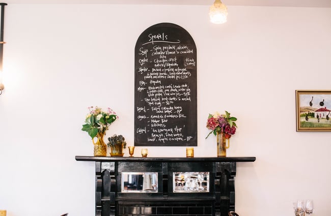 The menu black board over the fire place.