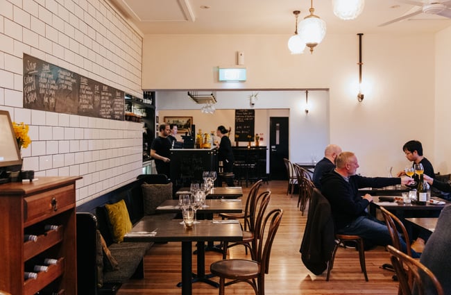 Customers dining at tables inside the restaurant.