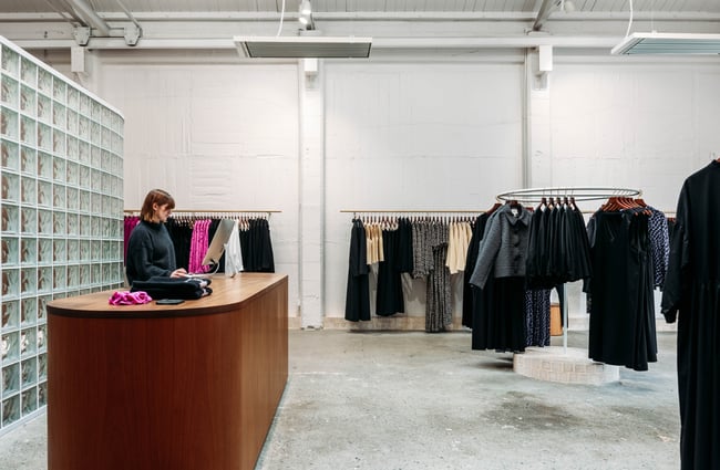 Shop assistant behind the counter at twenty-seven names.