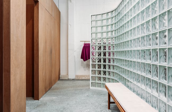 Changing rooms behind a glass feature wall at twenty-seven names.
