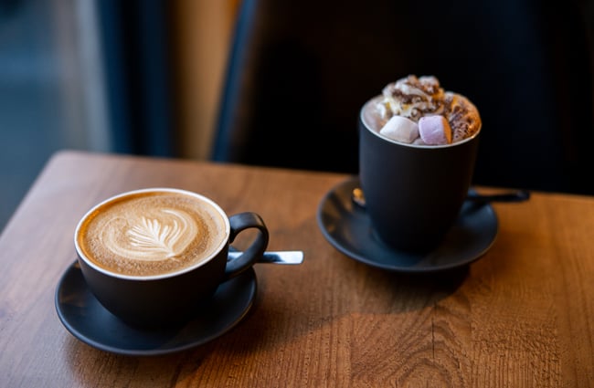 Coffee and hot chocolate on table at Two Thumb Harbourside
