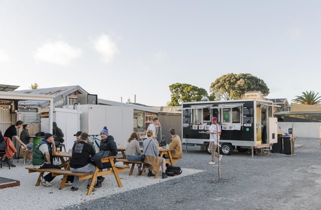 Customers sitting outside with food truck in the background at Two Thumb Brewing Co. Redcliffs.