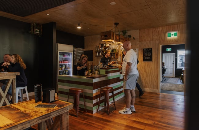 Customers ordering drinks at the bar at Two Thumb Brewing Co. Redcliffs.