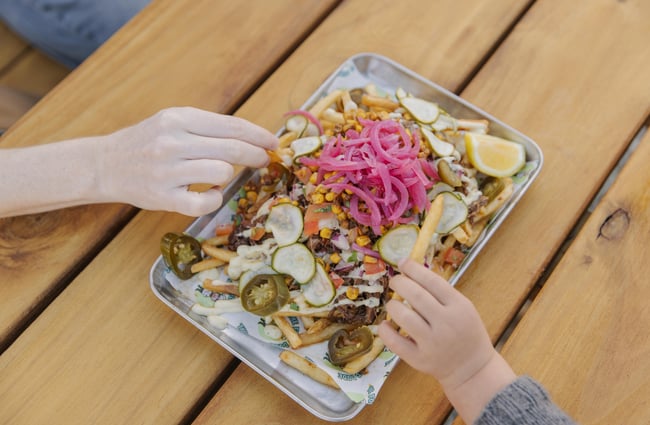 Customers enjoying a plate of food at Two Thumb Brewing Co. Redcliffs.