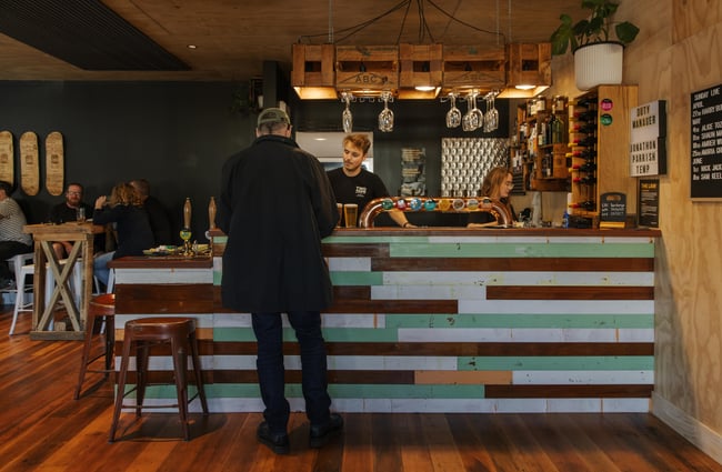 Customer ordering a drink at the bar at Two Thumb Brewing Co. Redcliffs.