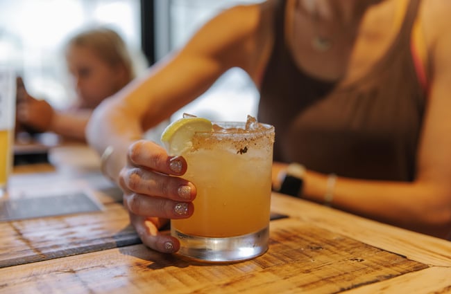 Customer holding their cocktail at Two Thumb Brewing Co. Redcliffs.