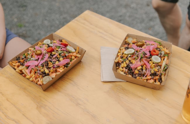 Two cardboard boxes of Mexican food on a table.