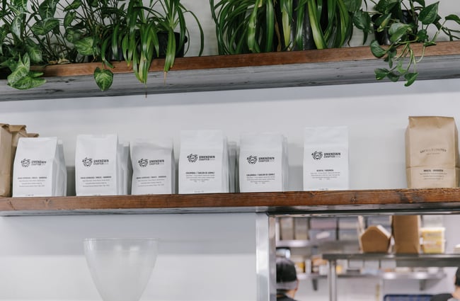 Bags of coffee for sale on a shelf.