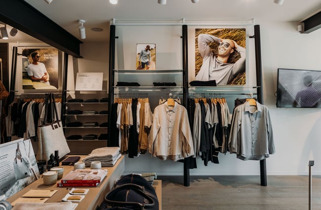 Men's clothing on racks along the wall at Untouched World, Wānaka.
