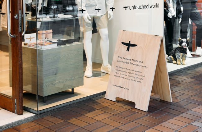 Wooden footpath sign outside Untouched World in Wellington.