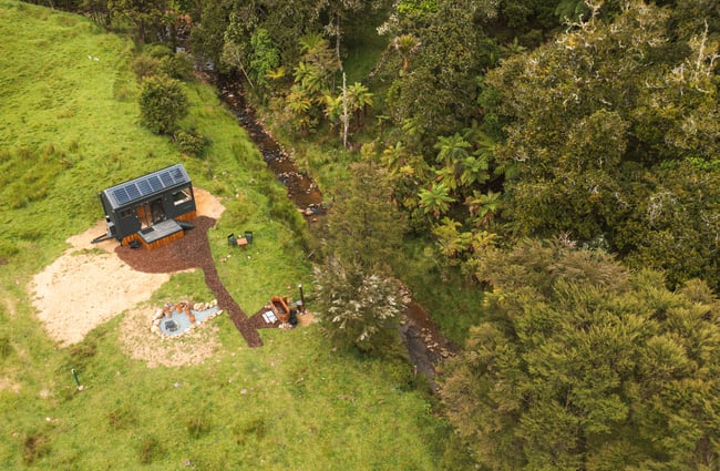 A birdseye view of a cabin in lush bush.