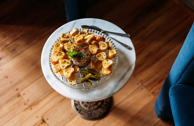 Plate of pate and croutons on marble side table