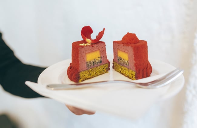 A patisserie cut open on a plate with detailing inside.